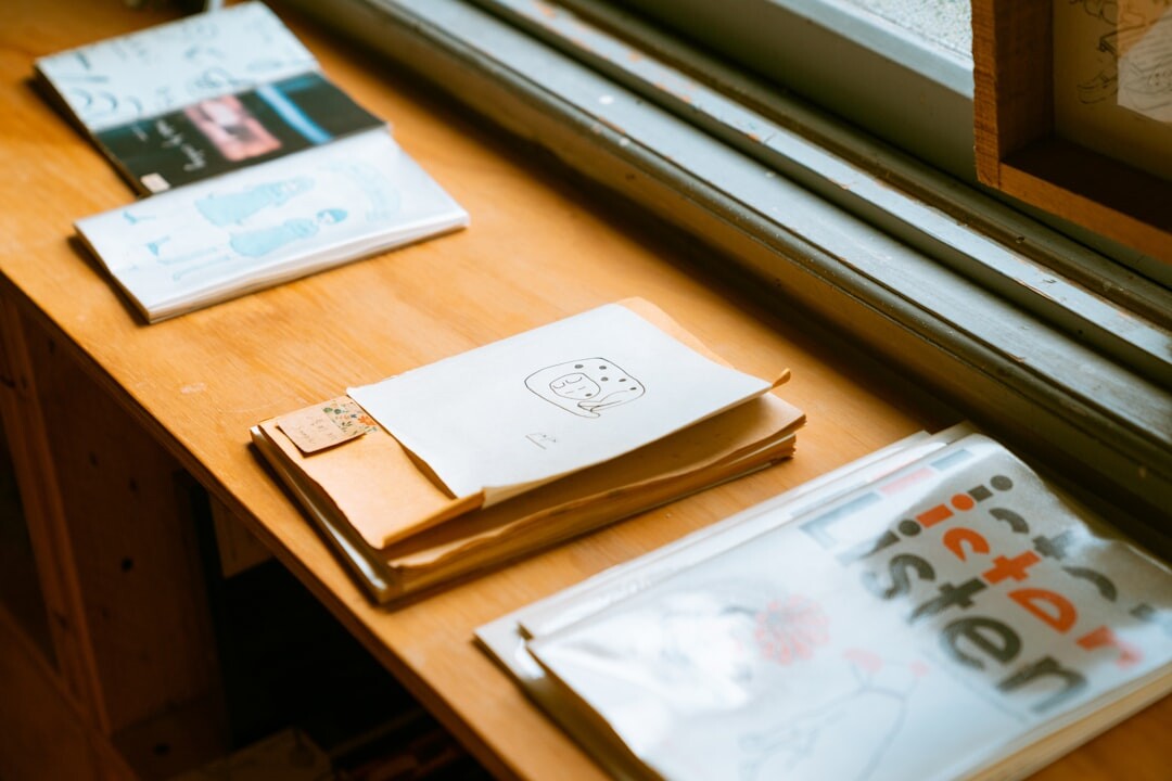 Journalist writing notes surrounded by interior design magazines